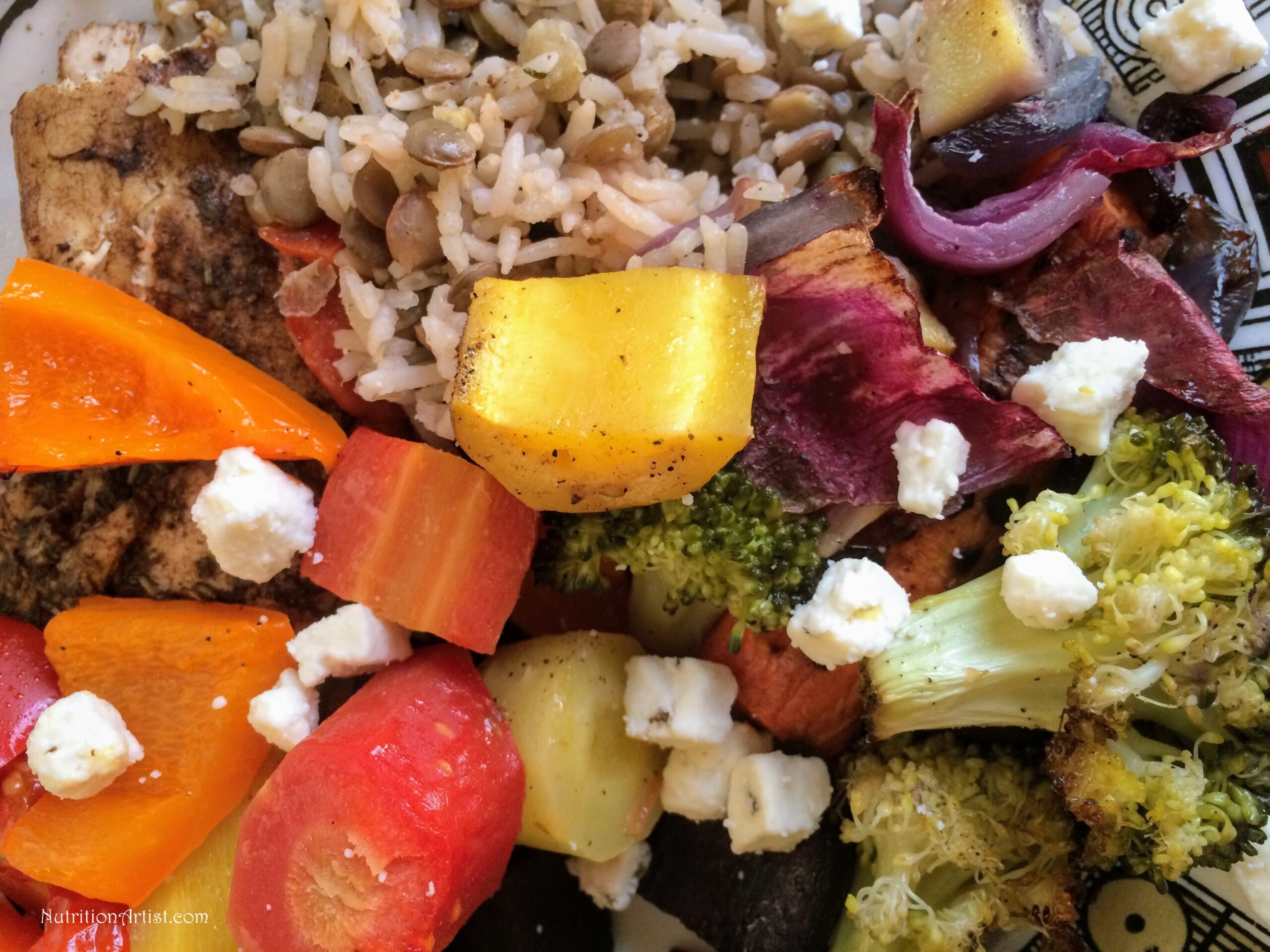 Rainbow Roasted Veggies recipe baked and mixed together and served with rice, lentils and feta cheese. 