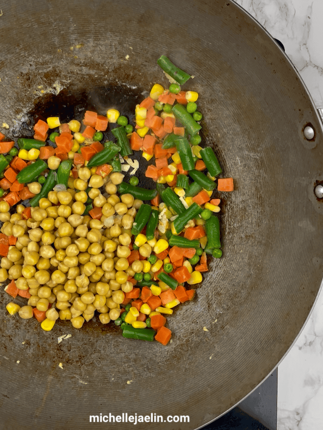 Mixed vegetables added to wok