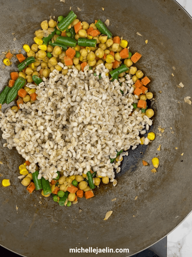 Cooked barley added to wok