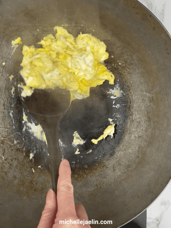 Eggs being scrambled together in wok