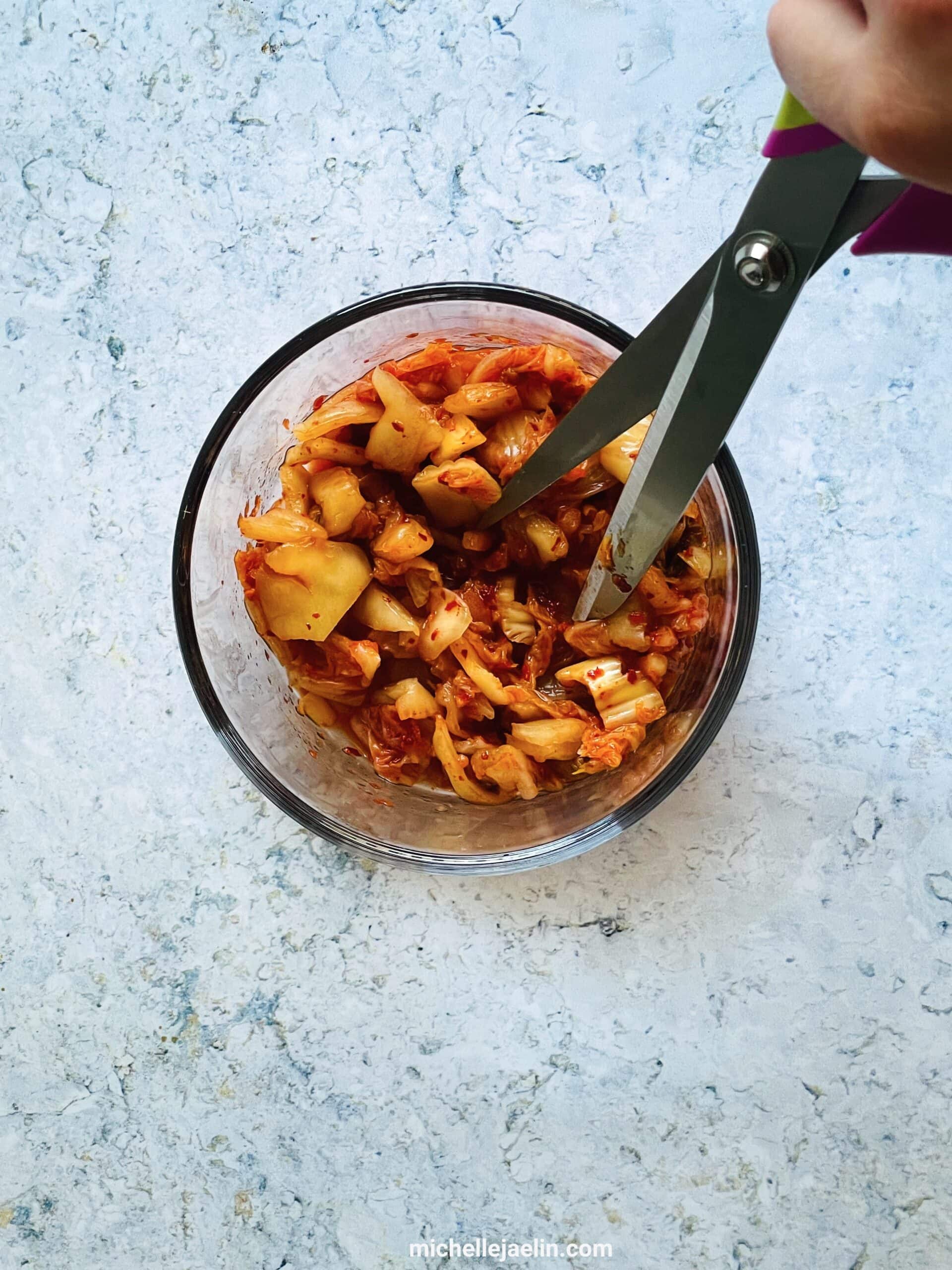 kimchi being cut by scissors