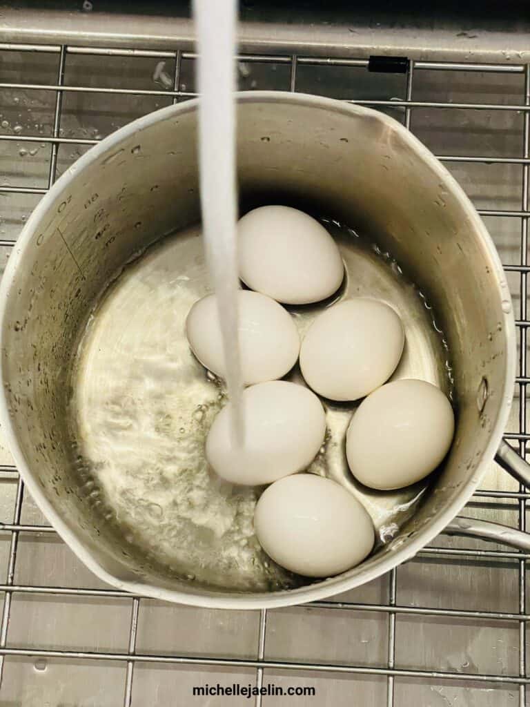 eggs in sauce pan being filled with water