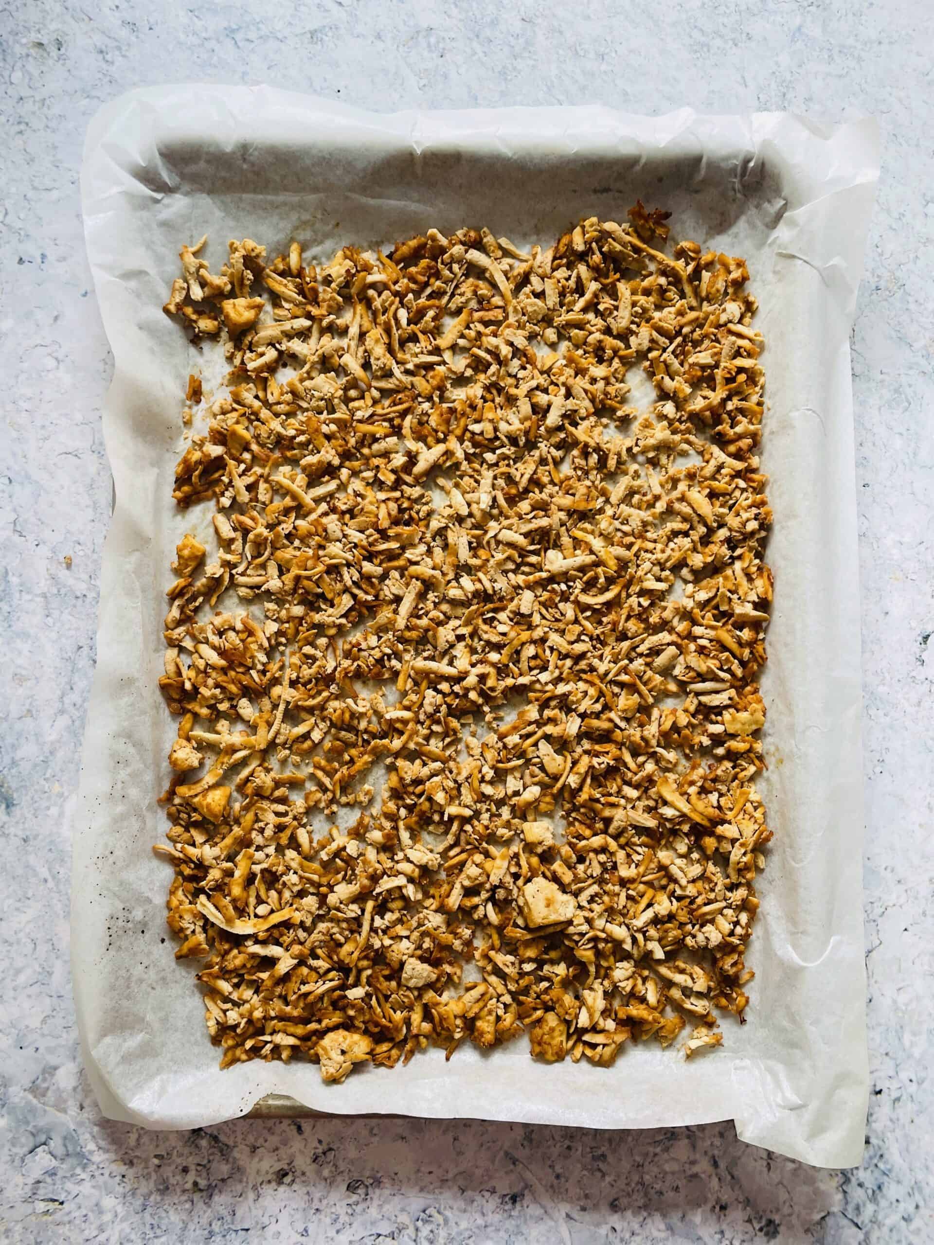 shredded tofu recipe on a baking sheet with parchment paper