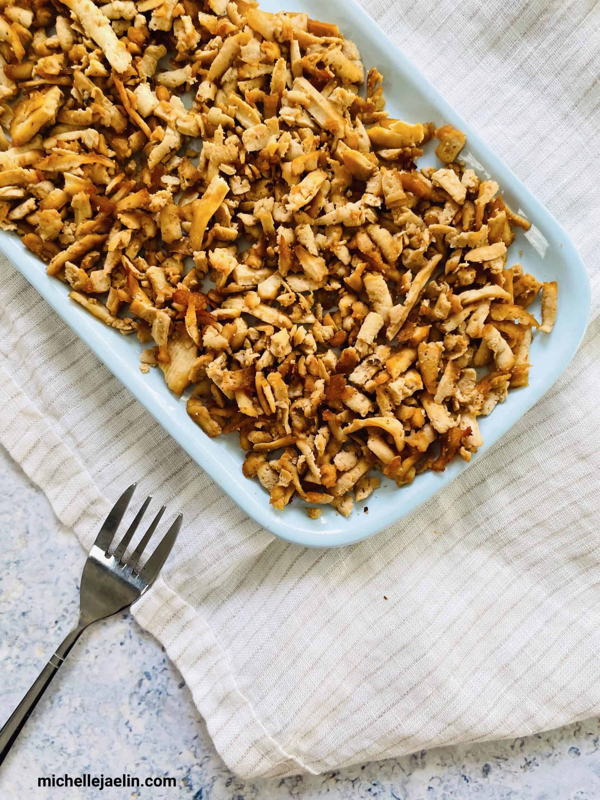 shredded tofu recipe on a plate with a fork