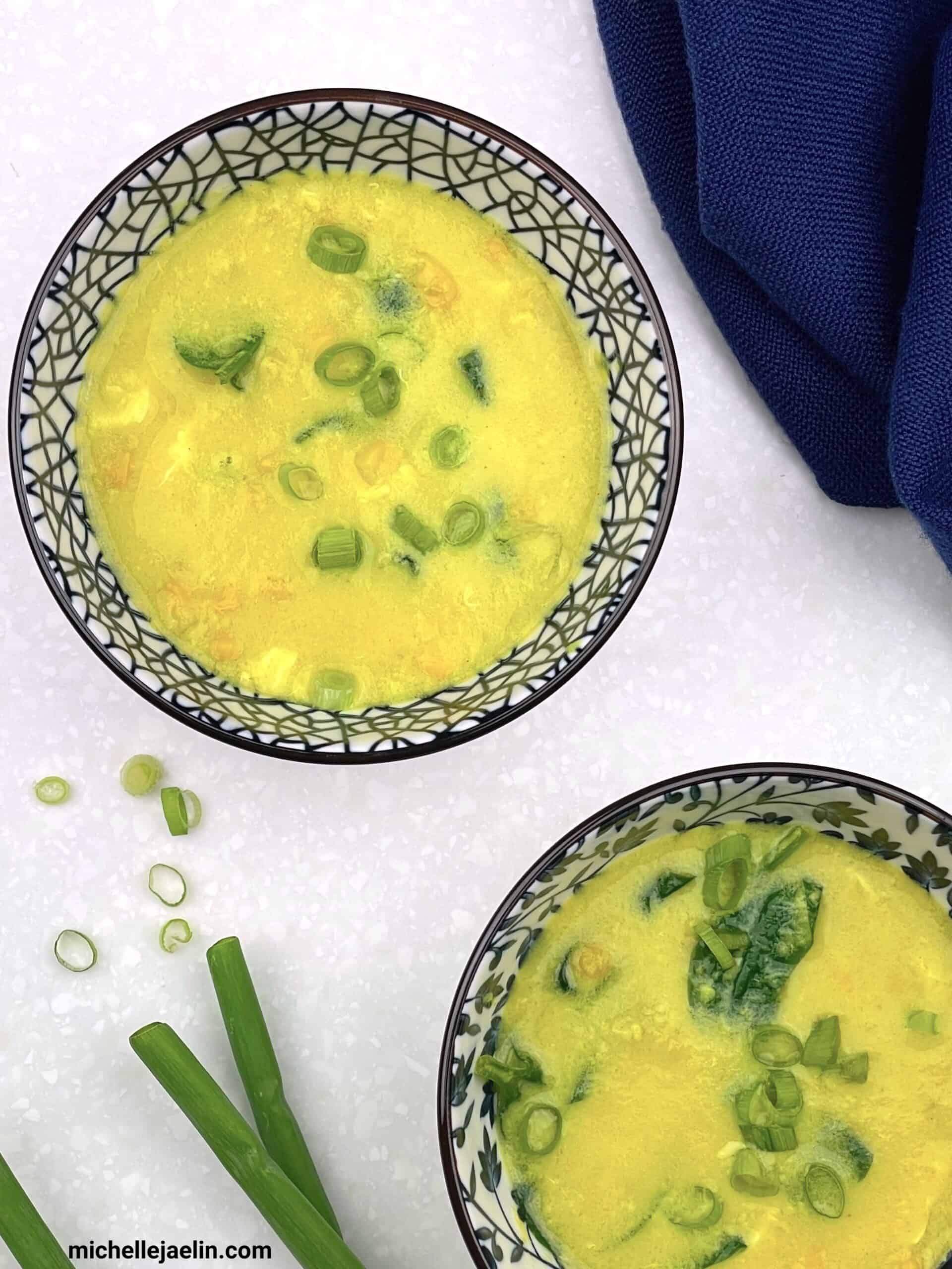 2 bowls of healthy vegetarian egg drop soup (gluten-free) with chopped green onions on the side