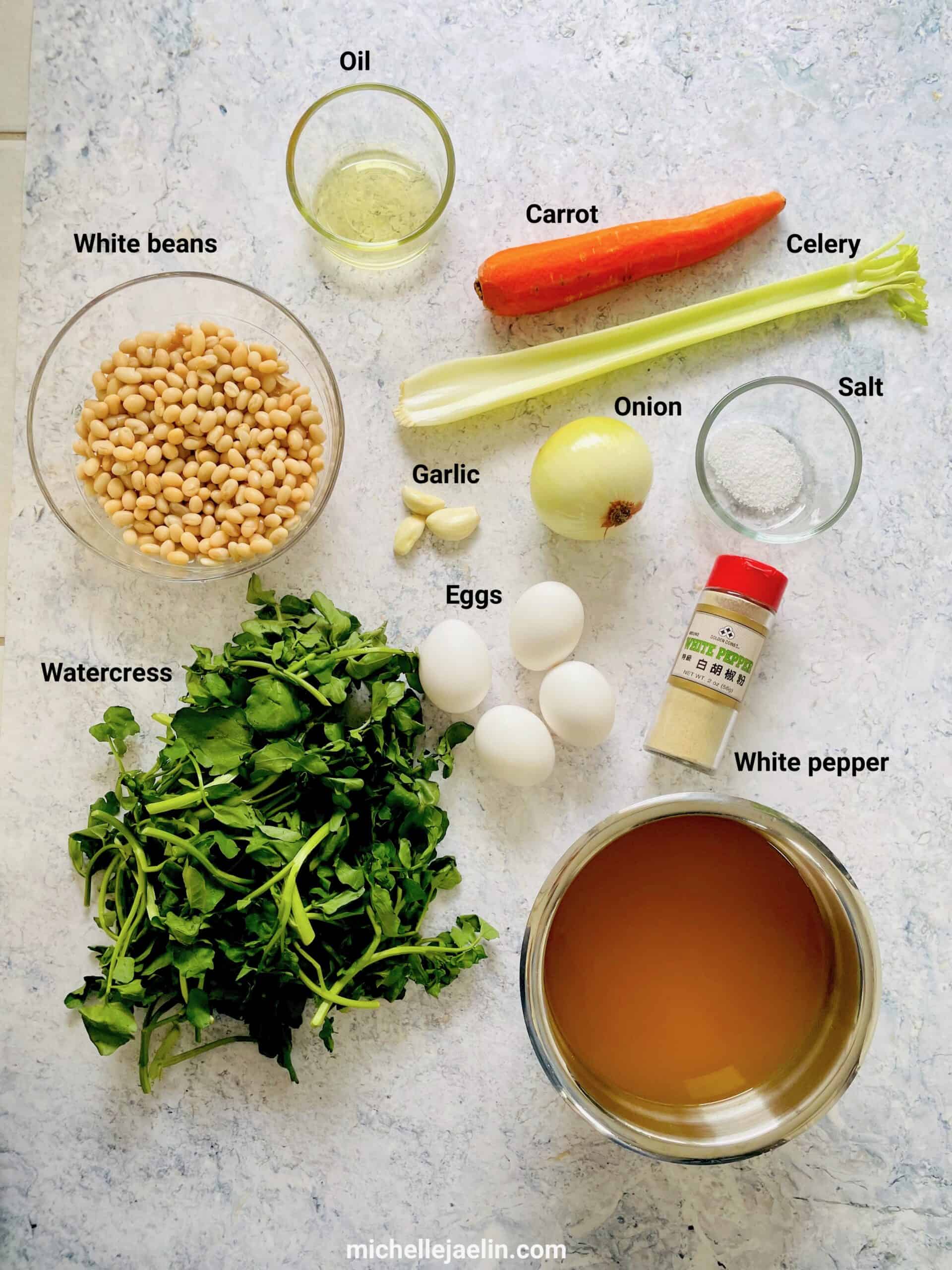 Recipe ingredients - oil, carrot, celery, white beans, garlic onion, salt, watercress, eggs, white pepper and vegetable stock